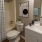 spacious bathroom with a tub, toilet and a mirror