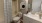 spacious bathroom with a tub, toilet and a mirror