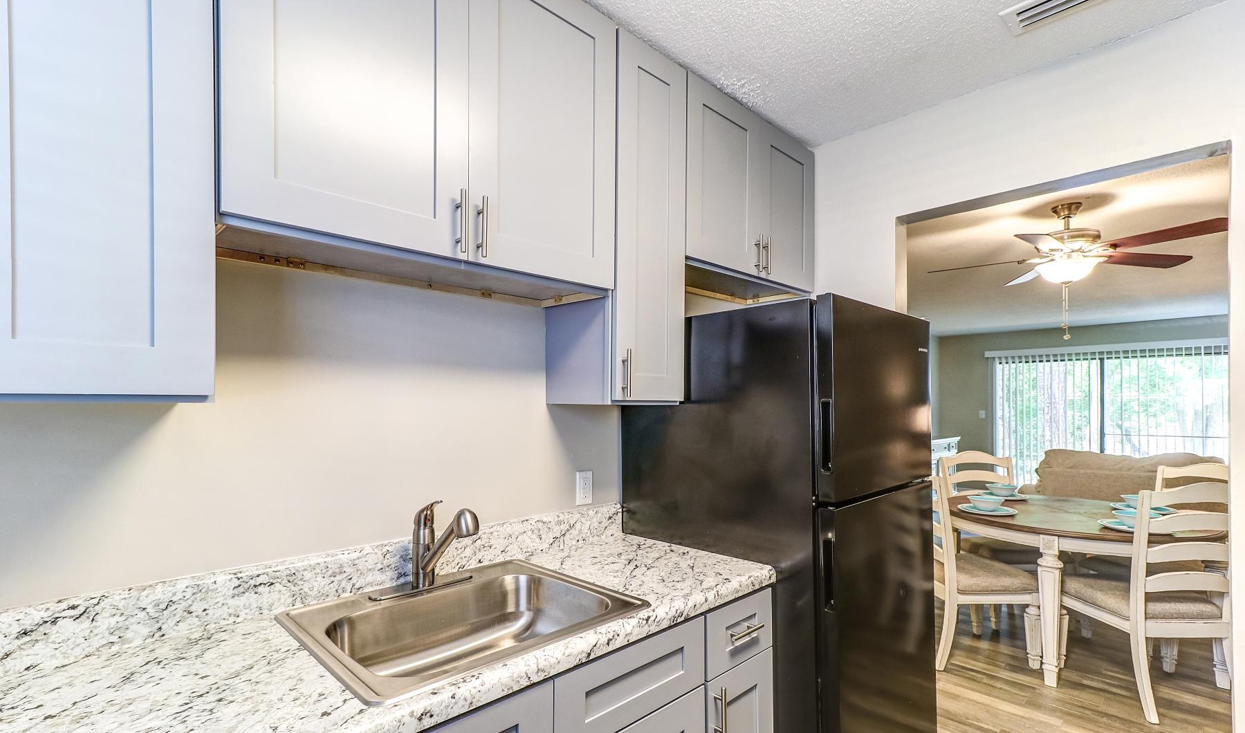 a kitchen with light cabinets