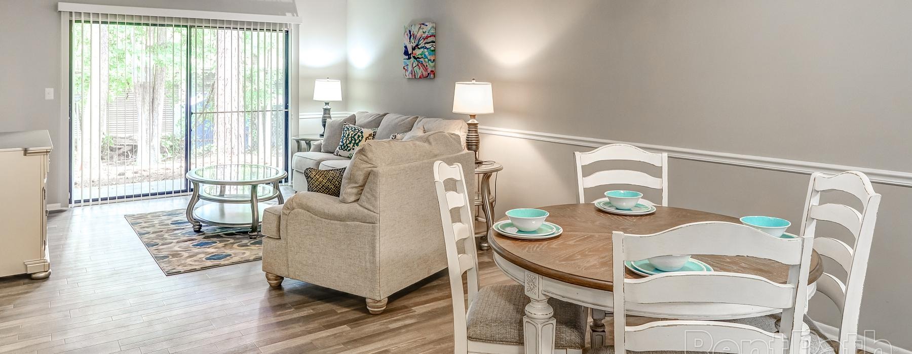 a living room with a table and chairs